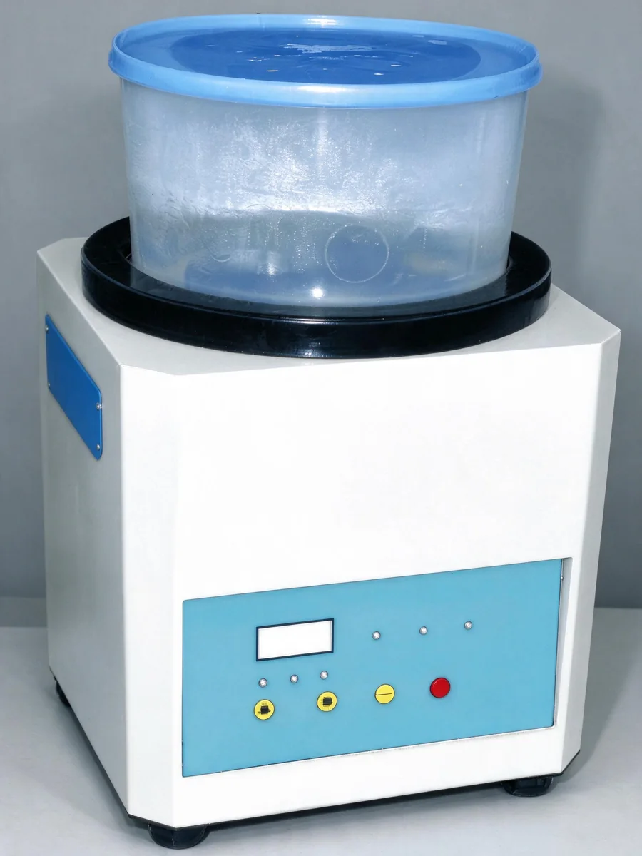White desktop magnetic polishing machine with blue control panel and translucent processing bucket.