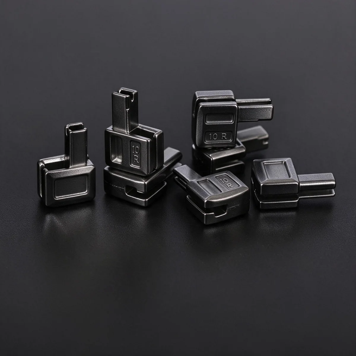 Close-up of silver metallic square lock inserts on black background