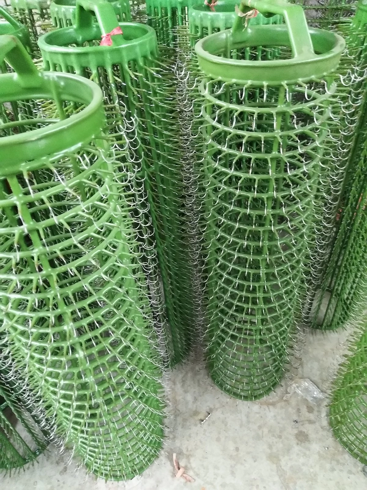Rack plating workshop - green coated racks carry parts through every t